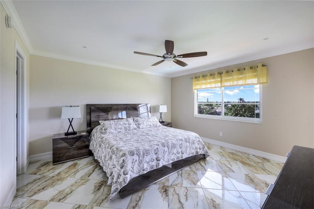 190 Pebble Beach Boulevard, Unit 502 Naples, FL 34113 - Photo 10 of 21 a bedroom with a large bed and a window