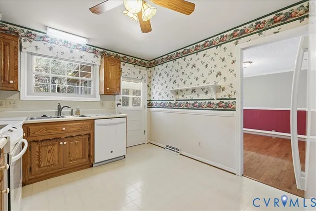 a kitchen with white cabinets and white appliances