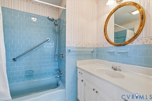 a bathroom with a sink a mirror a vanity and a bathtub