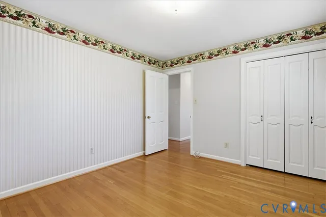 a view of a room with wooden floor and windows