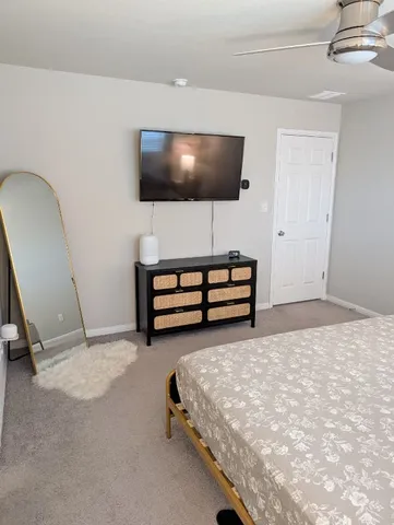 a bed sitting in a bedroom next to a window