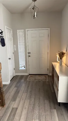a view of a livingroom with wooden floor and staircase