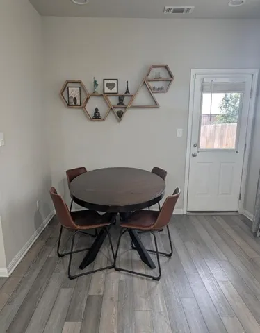 a view of a dining room with furniture and wooden floor