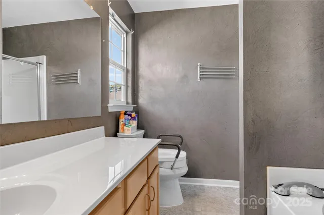 a bathroom with a sink a toilet and a shower