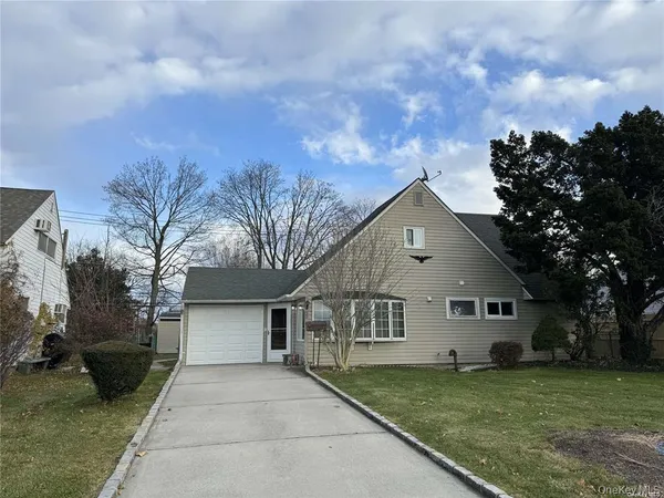 a front view of house with yard and trees