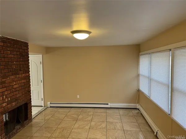 a view of an empty room and fire place