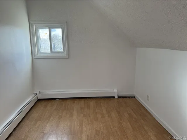 a view of a room with wooden floor and window