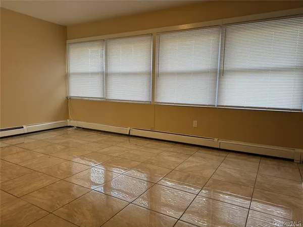 a view of a room with wooden floor and windows
