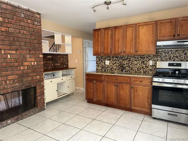 a kitchen with stainless steel appliances a stove sink and cabinets