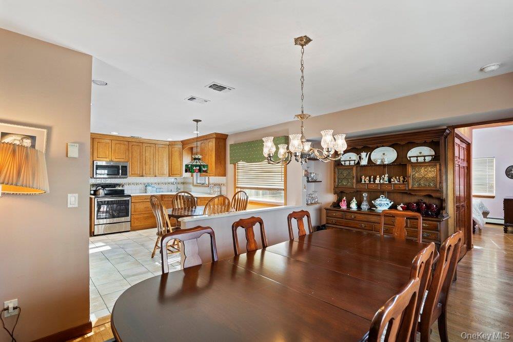18 Barry Lane Syosset, NY 11791 - Photo 12 of 37 a living room with lots of furniture and a chandelier