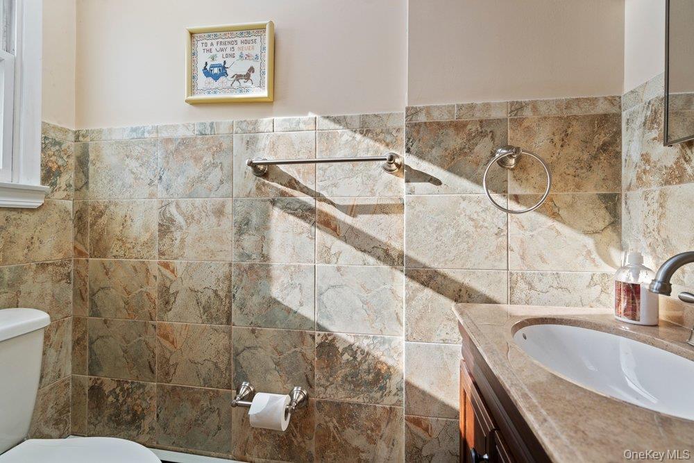 18 Barry Lane Syosset, NY 11791 - Photo 18 of 37 a bathroom with a granite countertop sink a toilet and bathtub