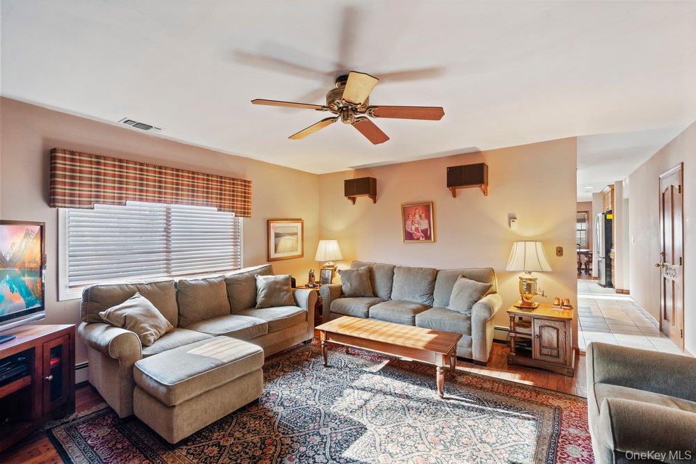 18 Barry Lane Syosset, NY 11791 - Photo 20 of 37 a living room with furniture a couch and a window