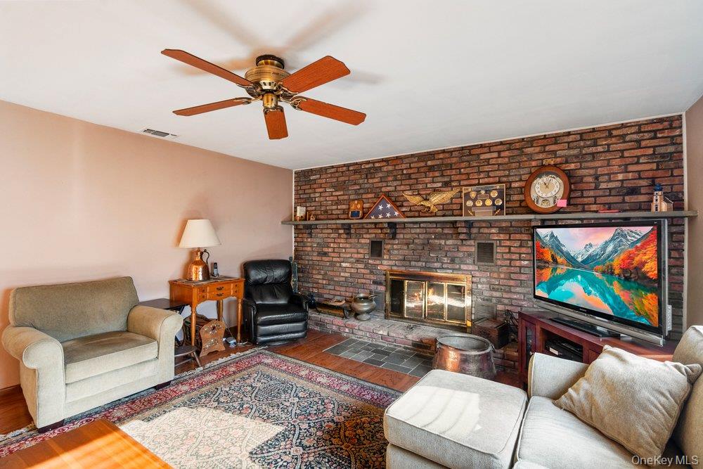 18 Barry Lane Syosset, NY 11791 - Photo 21 of 37 a living room with furniture and a fireplace