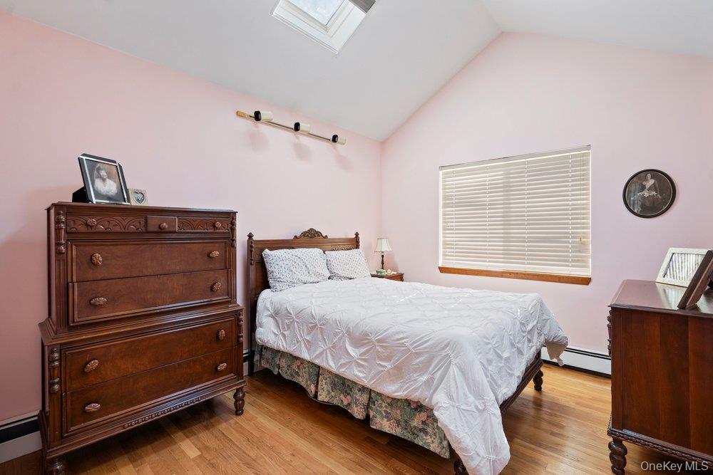 18 Barry Lane Syosset, NY 11791 - Photo 22 of 37 a bedroom with a bed and a cabinets