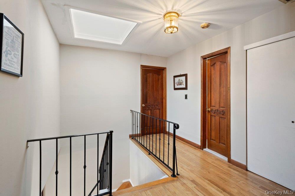 18 Barry Lane Syosset, NY 11791 - Photo 25 of 37 a view of a hallway with wooden floor and staircase