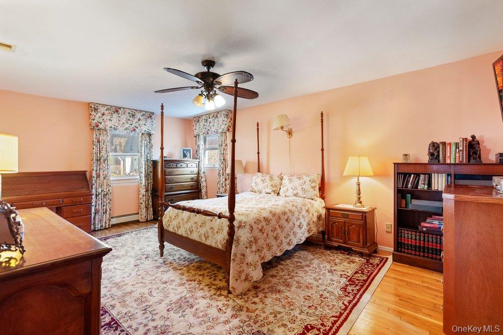 18 Barry Lane Syosset, NY 11791 - Photo 26 of 37 a spacious bedroom with a bed a dresser and book shelf