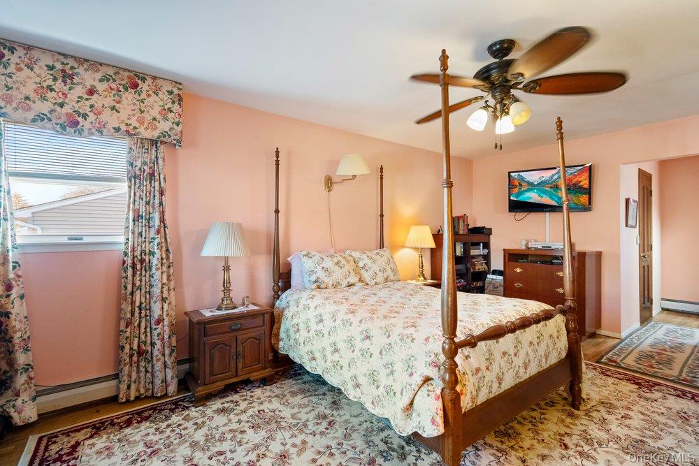 18 Barry Lane Syosset, NY 11791 - Photo 28 of 37 a bed room with a bed and a chandelier