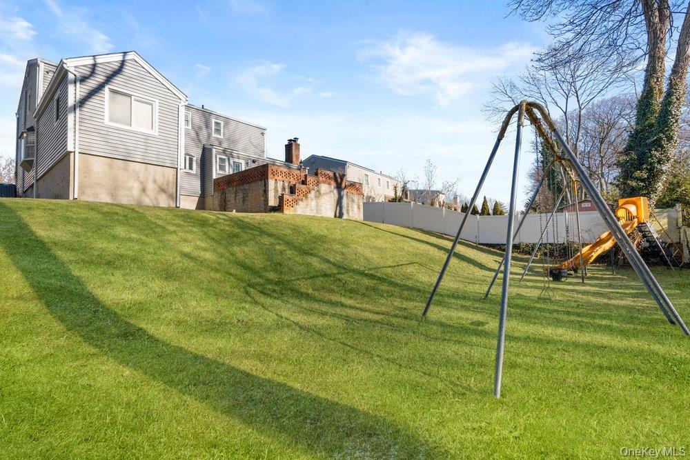 18 Barry Lane Syosset, NY 11791 - Photo 35 of 37 a view of an house with backyard and a slide