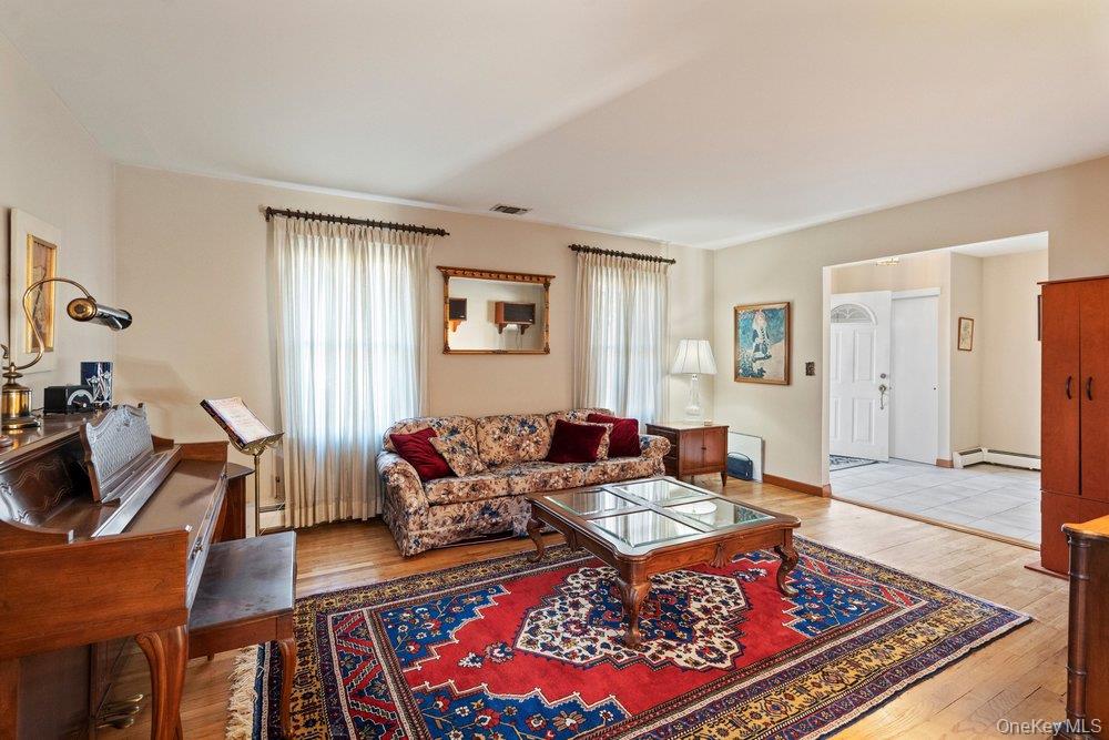 18 Barry Lane Syosset, NY 11791 - Photo 7 of 37 a living room with furniture a rug and a window