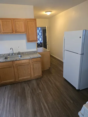 a kitchen with wooden cabinets and white appliances