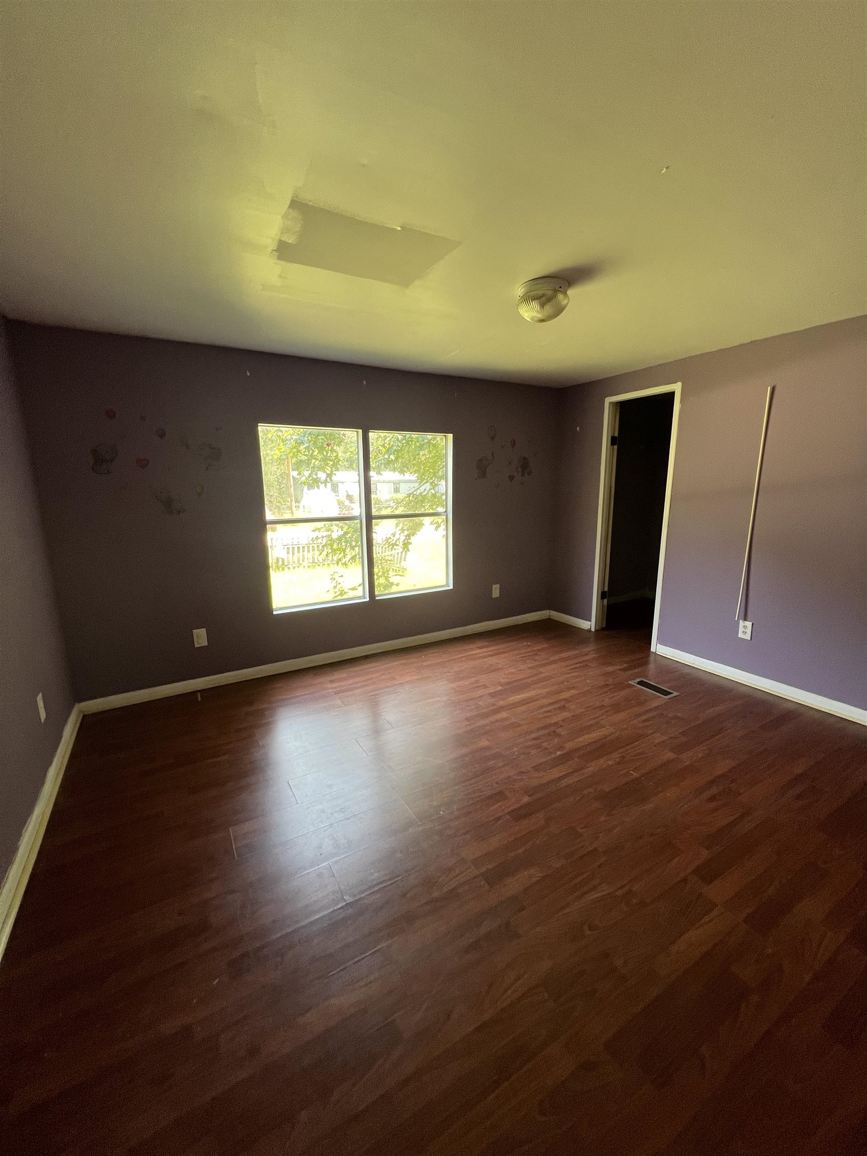 6473 Capri Isle St. Augustine, FL 32095 - Photo 5 of 7 a view of an empty room with wooden floor and a window