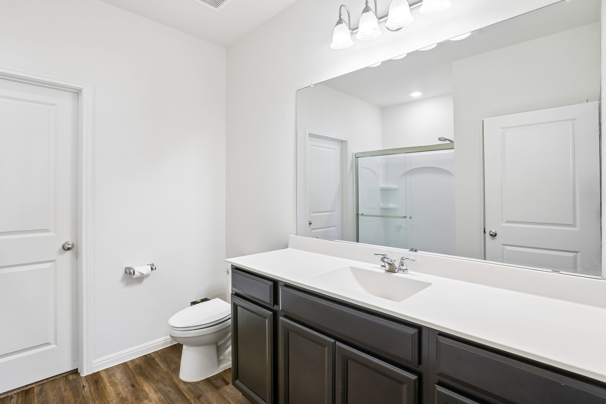 19105 Mike Mansfield Road Manor, TX 78653 - Photo 16 of 28 a bathroom with a sink a toilet and shower