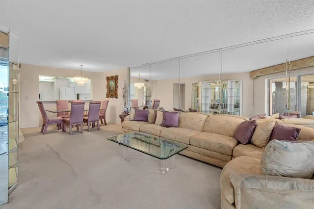a living room with furniture and a floor to ceiling window