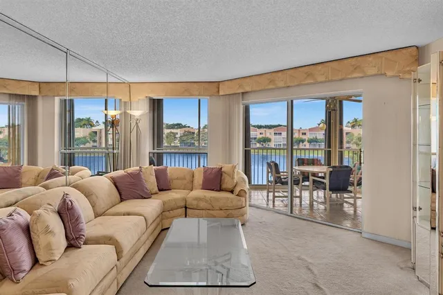 a spacious bedroom with a bed and a chandelier