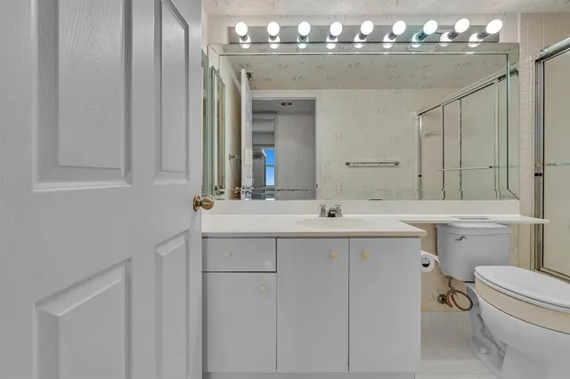 a dining room with furniture a chandelier and wooden floor