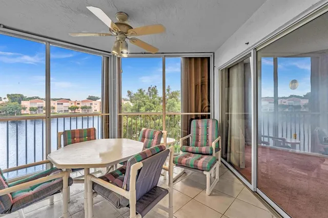 a living room with furniture and view of kitchen