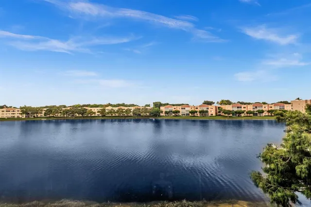 an aerial view of a city with lots of residential buildings and mountain view in back