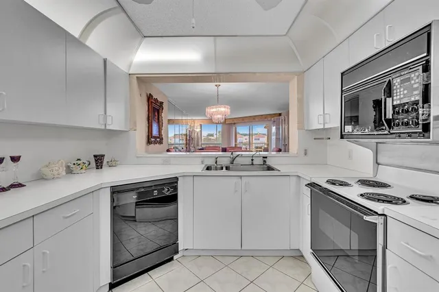 a kitchen with white cabinets and a refrigerator