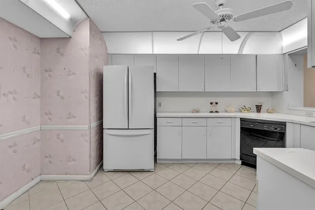 a kitchen with stainless steel appliances granite countertop a sink a stove a refrigerator and island