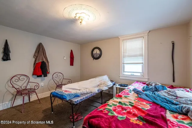 a bedroom with furniture and a window