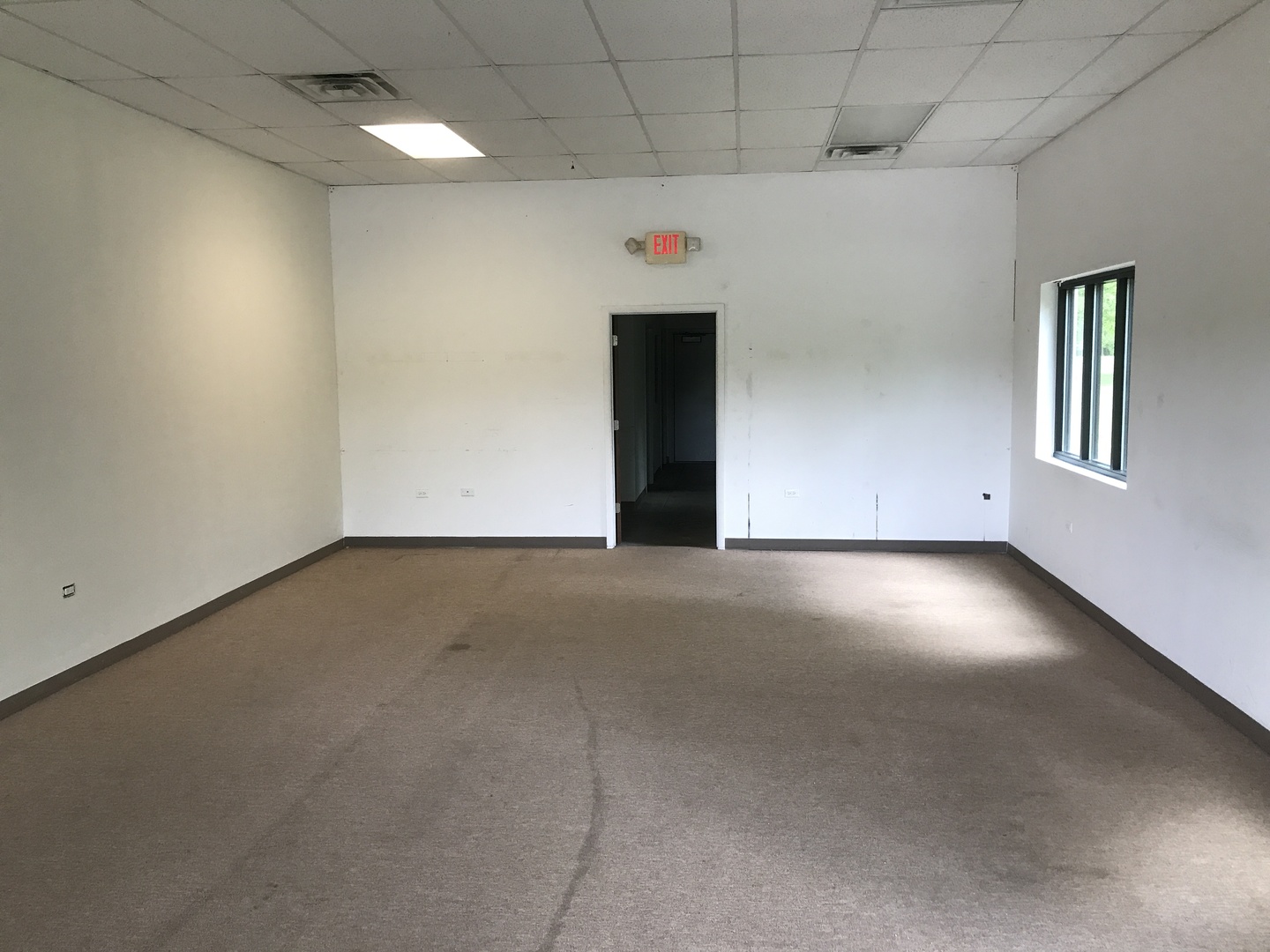 12033 Antioch Road, Unit G Trevor, WI 53179 - Photo 6 of 8 an empty room with windows
