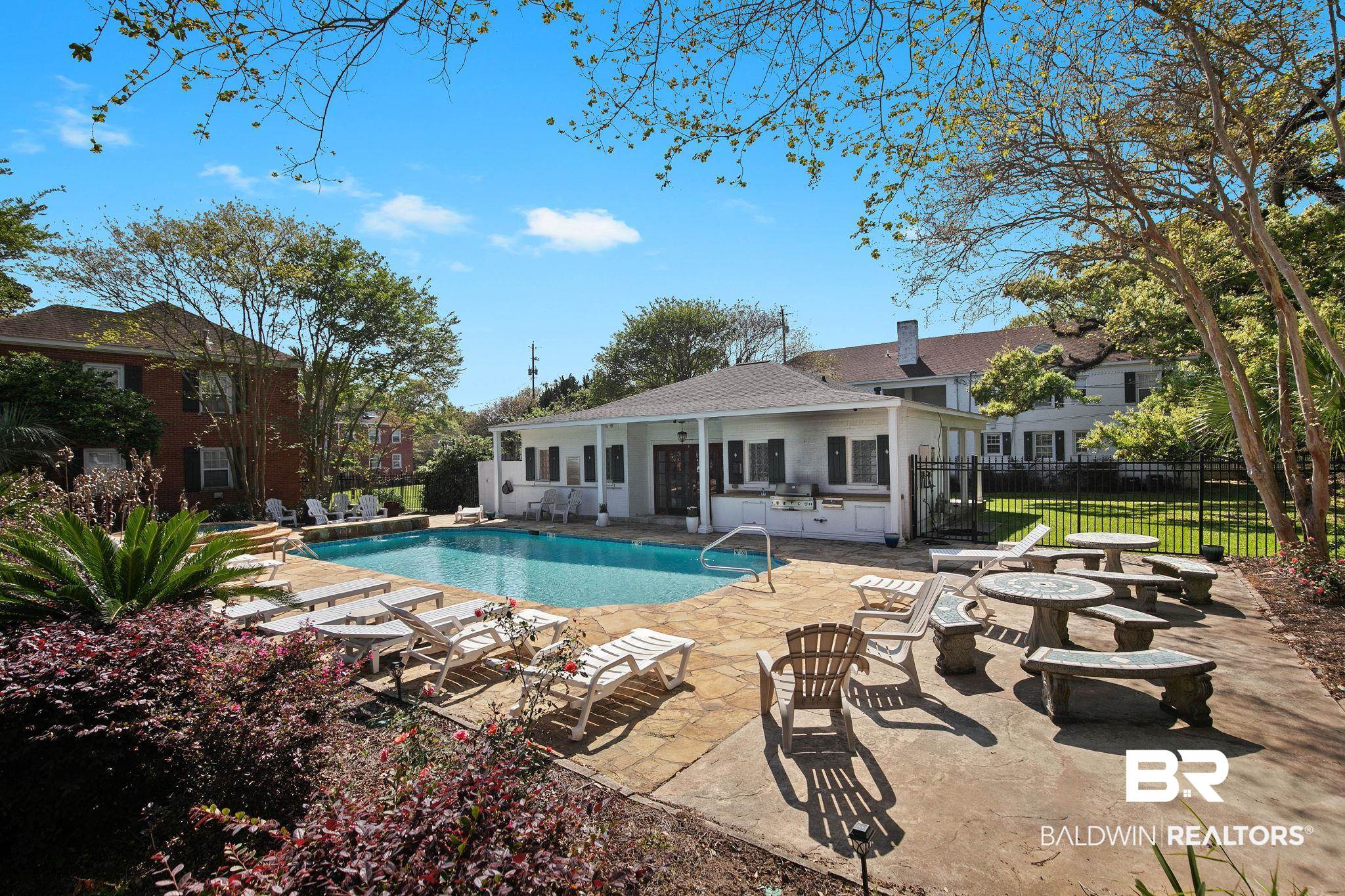 214 Upham Street, Unit 8D Mobile, AL 36607 - Photo 32 of 36 View of swimming pool featuring patio surround, a grill, and a fire pit