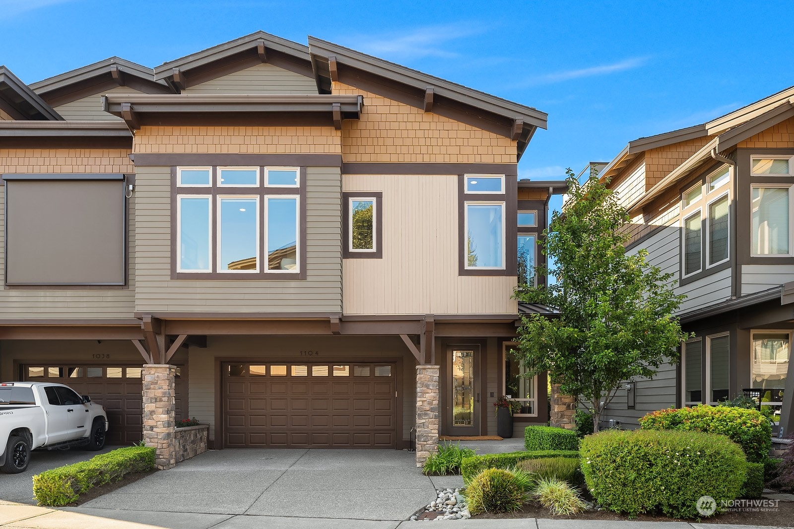 1104 North 41st Place Renton, WA 98056 - Photo 1 of 40 a front view of a house with garden