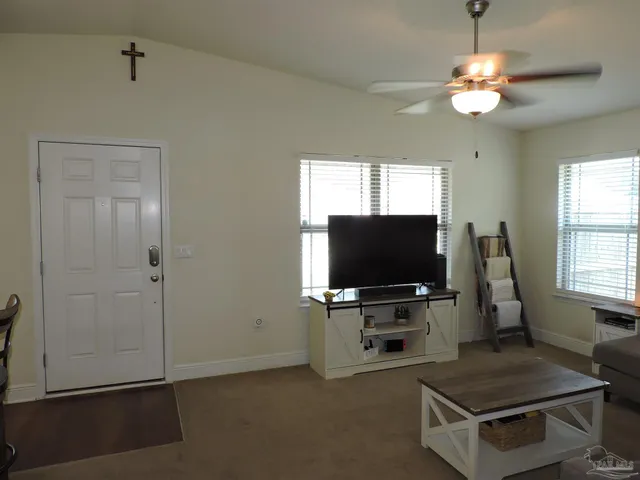 a living room with furniture and flat screen tv