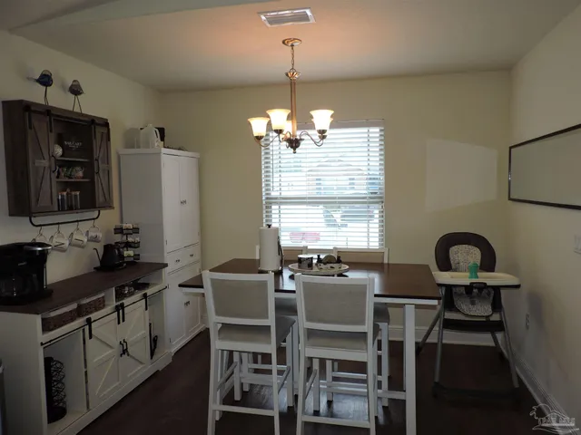 a view of a dining room with furniture window and outside view