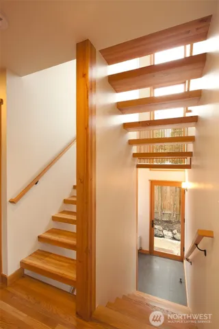 a view of a room with wooden floor and windows