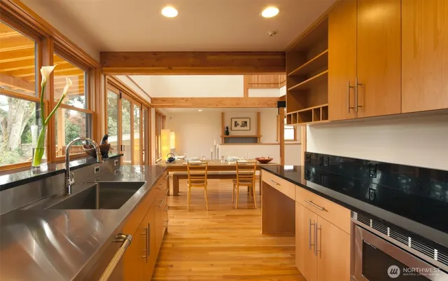 a large white kitchen with a large window