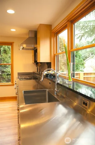 a kitchen with sink and large window