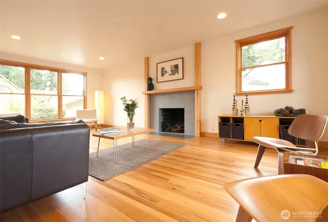 a living room with furniture large window and a fireplace