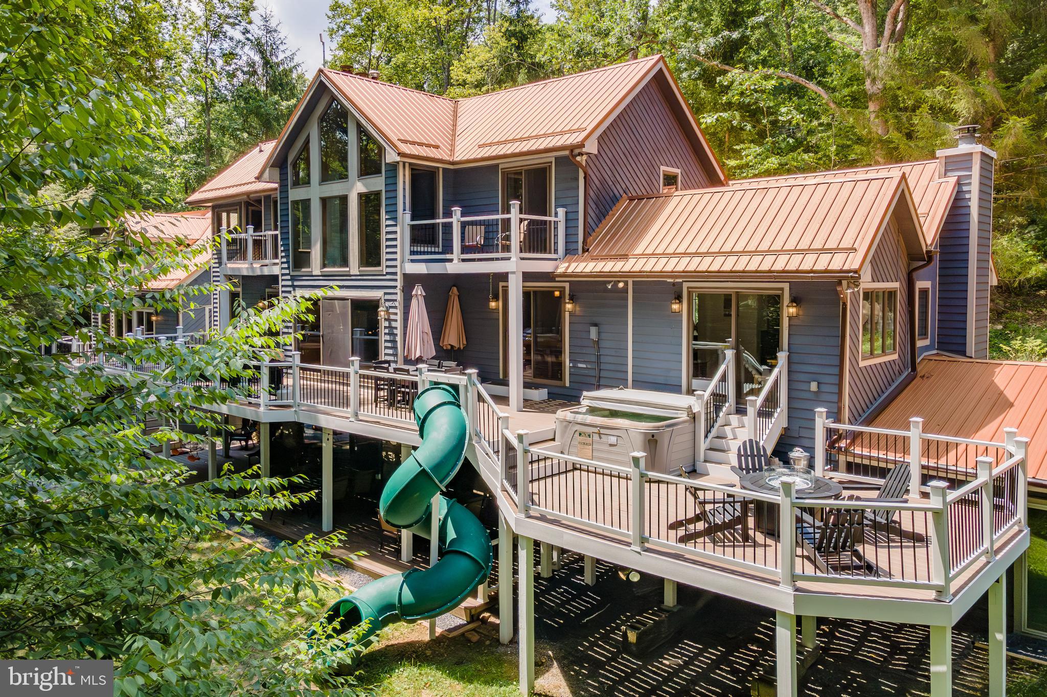 2463 Mayhew Inn Road Oakland, MD 21550 - Photo 1 of 144 a view of a house with a porch and furniture