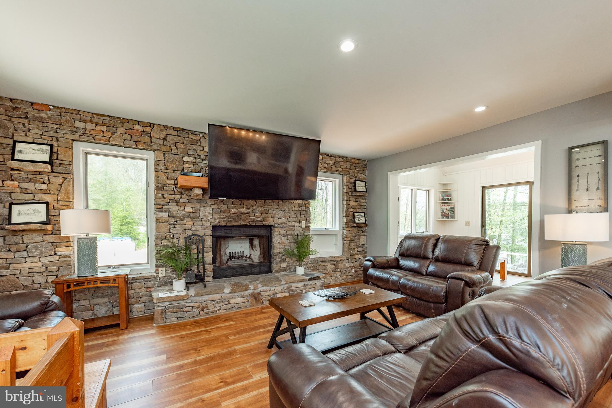 2463 Mayhew Inn Road Oakland, MD 21550 - Photo 27 of 144 a living room with furniture fireplace and a flat screen tv