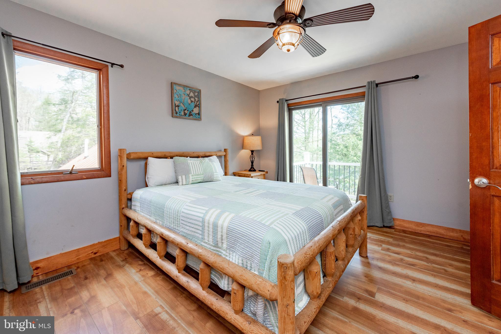 2463 Mayhew Inn Road Oakland, MD 21550 - Photo 58 of 144 a large bed sitting in a bedroom next to a window