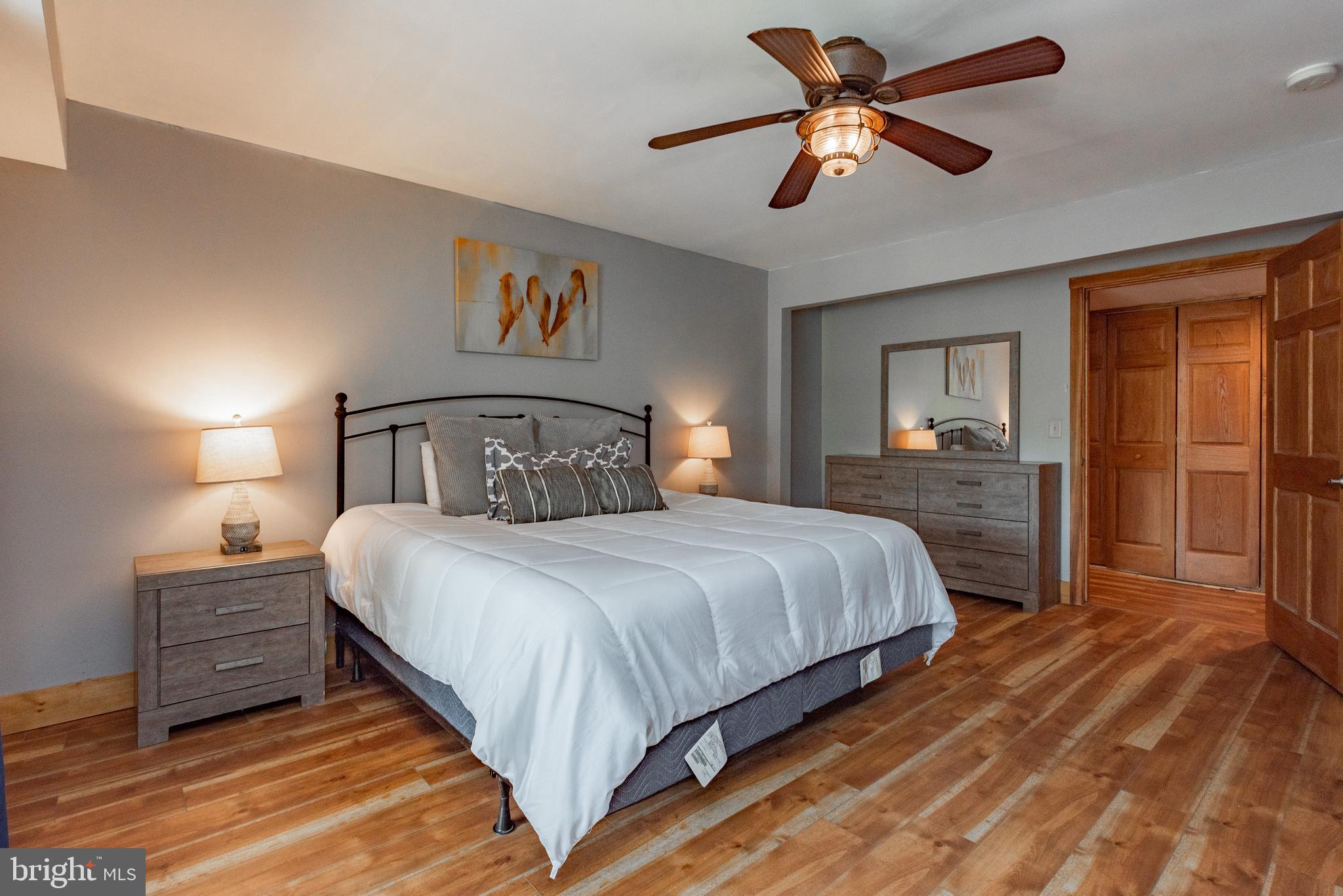 2463 Mayhew Inn Road Oakland, MD 21550 - Photo 70 of 144 a bedroom with a bed and a chandelier