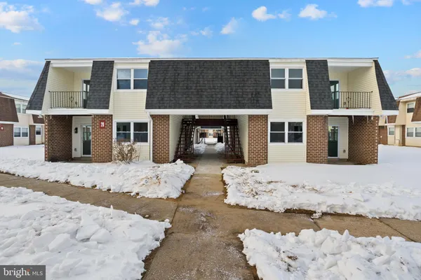 a view of a house with snow on the road