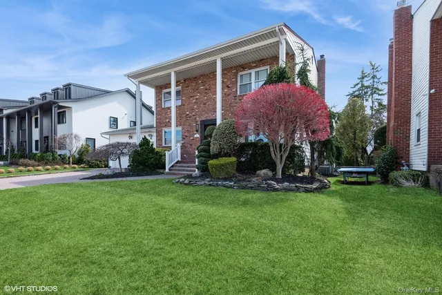 a view of a house with a yard and sitting area
