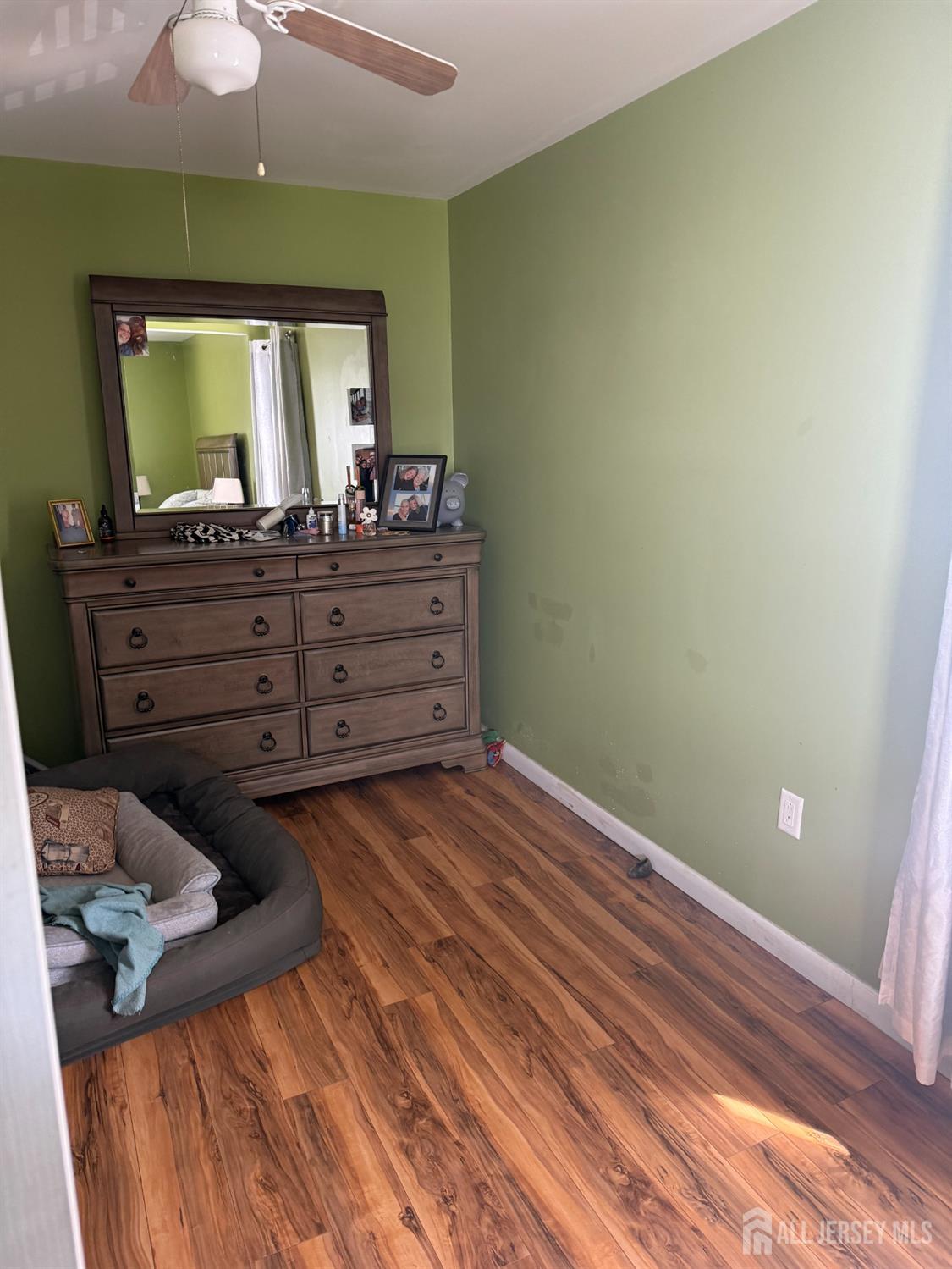 31 Edwin Street Carteret, NJ 07008 - Photo 11 of 18 a room with a bed and a mirror on dresser